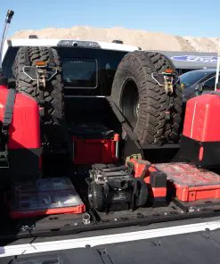 Rear view of an F-150 bed with dual VSTMs, center tray, rear PACKOUT mounts and fuel jug holders