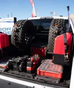 Angled view of an F-150 BASE layout with PACKOUT storage, upright spare tires and center-mounted equipment