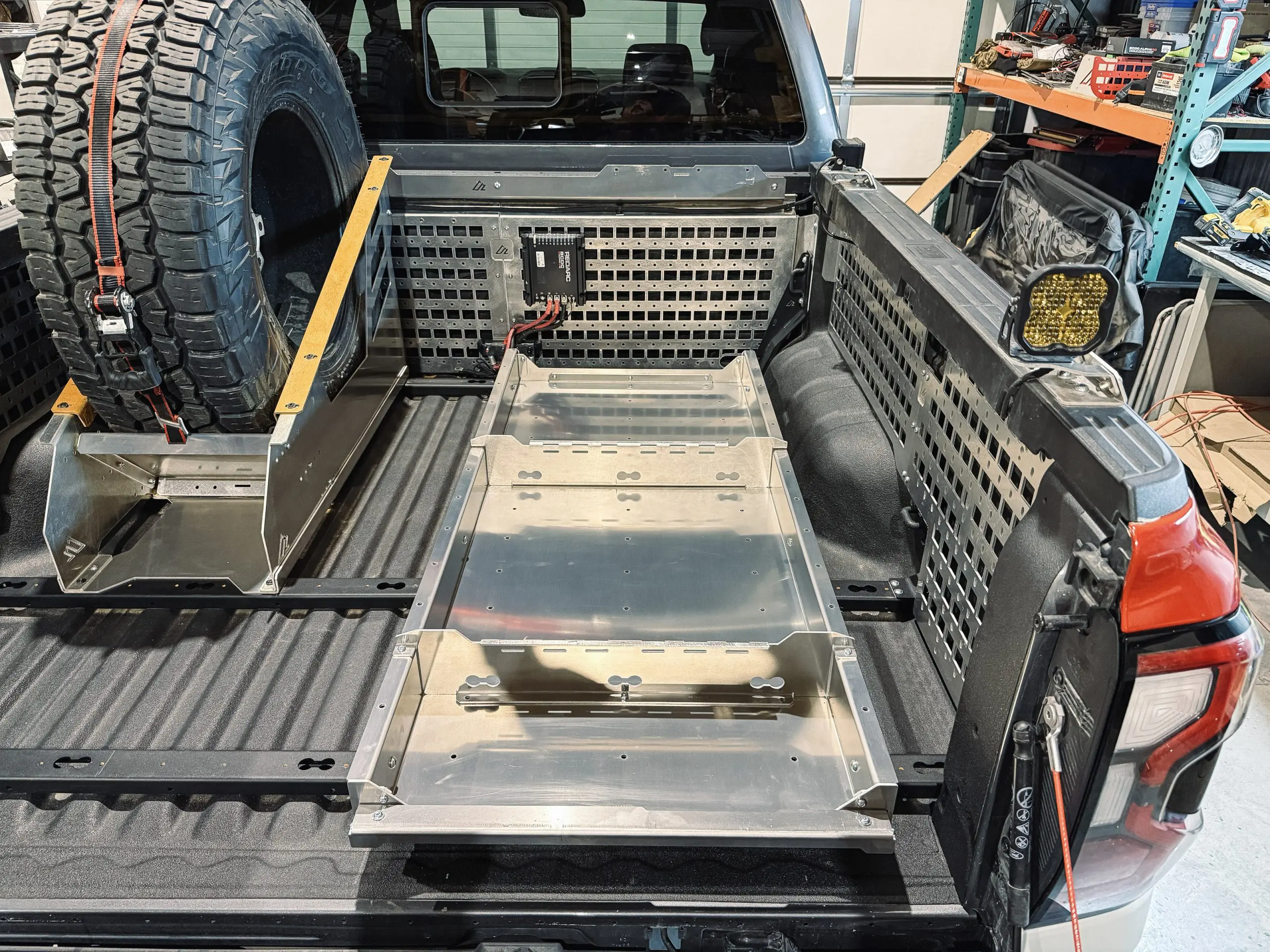 One Ranger vertical spare tire mount installed beside a BASE bed slide